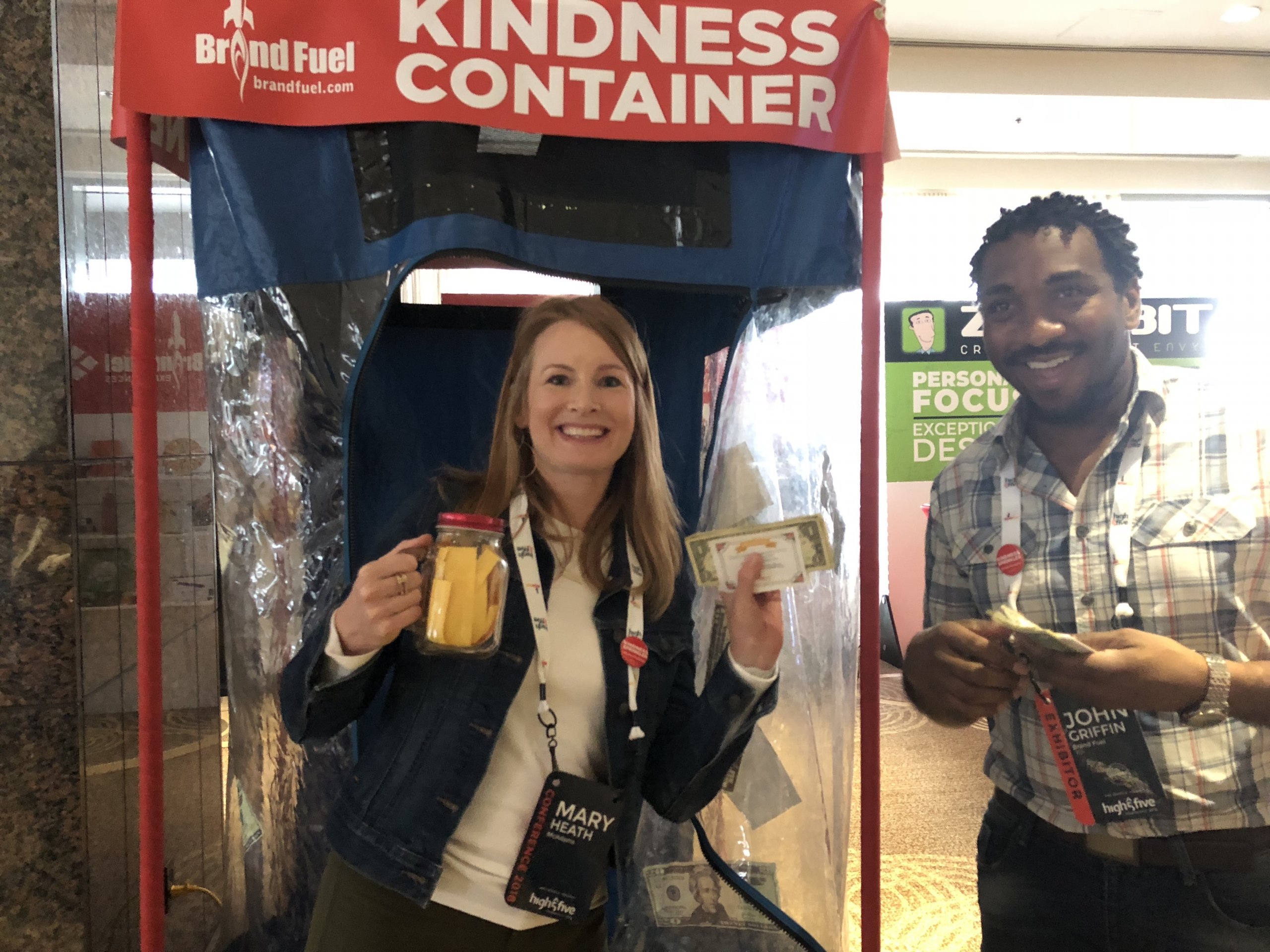 A woman showcasing what she won at the Kindness Container.