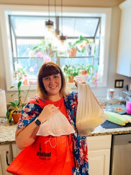 Photo of BrandFuel Aarica Burkholder holding produce bags.