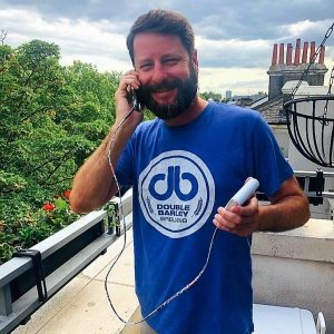 Photo of BrandFuel employee Alex Stowe talking on his smart phone.