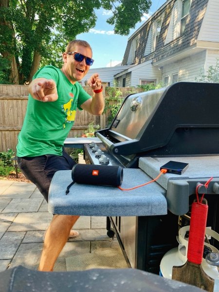 Zach Sarner posing next to a grill