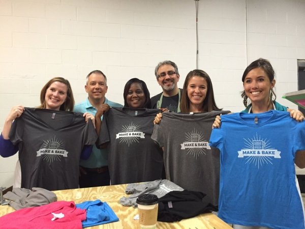People showcasing their "Make and Bake" shirts