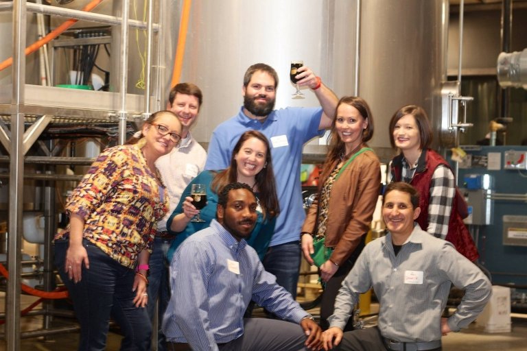 People posing for a photo during a "Taste" event.