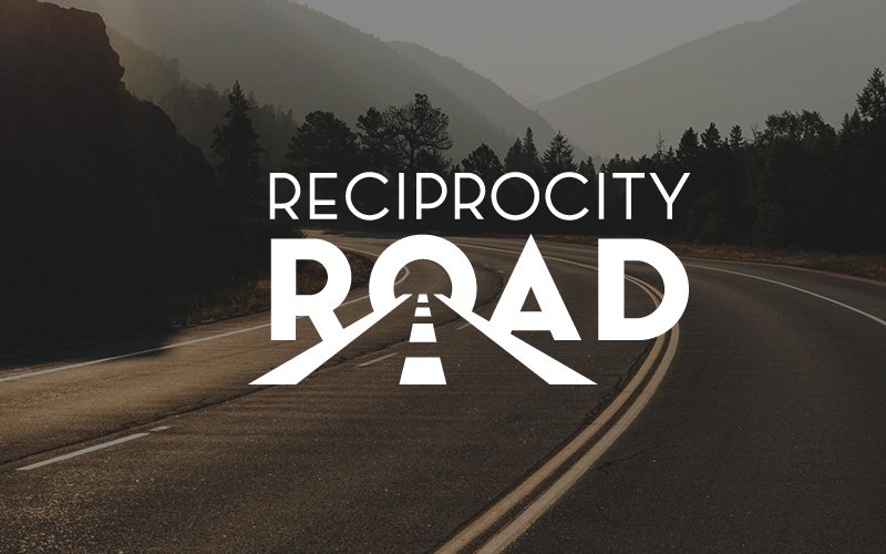 Reciprocity Road logo on top of photograph of a bending road and mountains