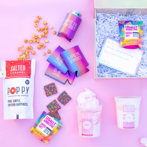 An arrangement of snack foods and branded drink coozies.