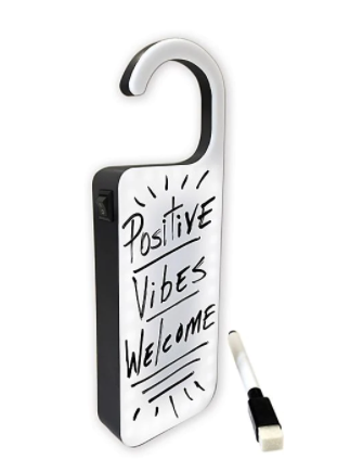 Doorknob hanger made out of a whiteboard that has Positive Vibes Only written on it in black marker.